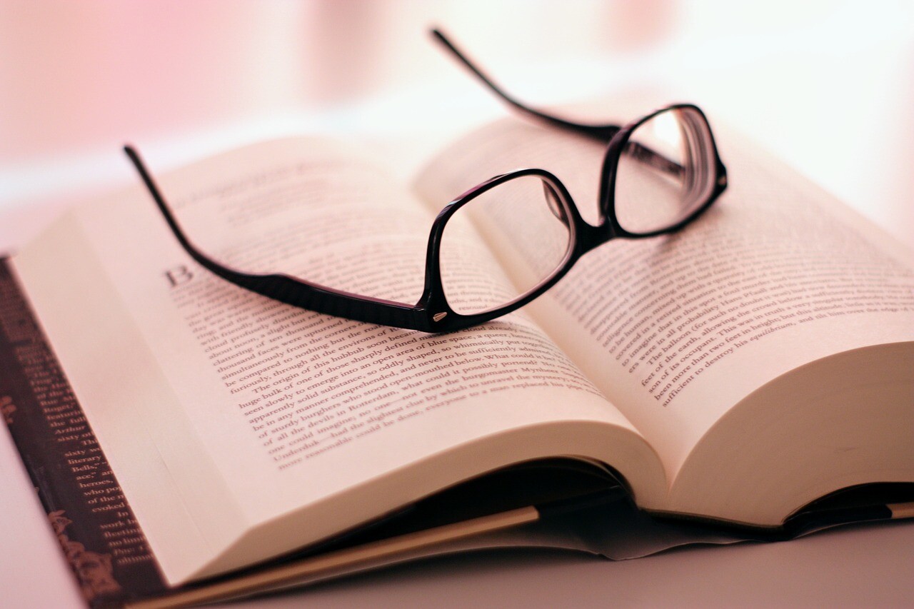 本の上に置かれた勉強用の眼鏡